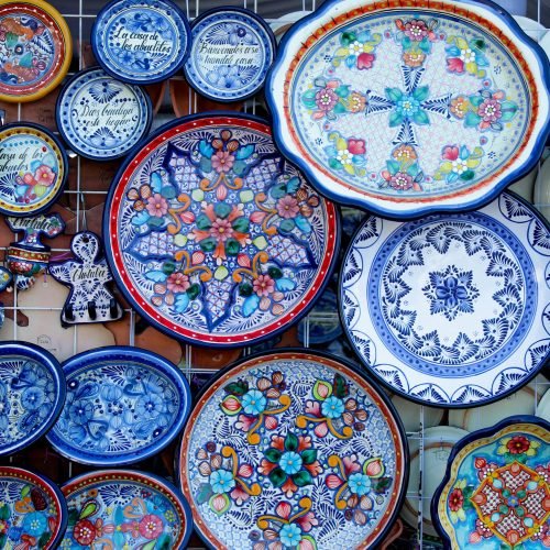 A colorful array of handcrafted Talavera plates and pottery in Cholula, Puebla.